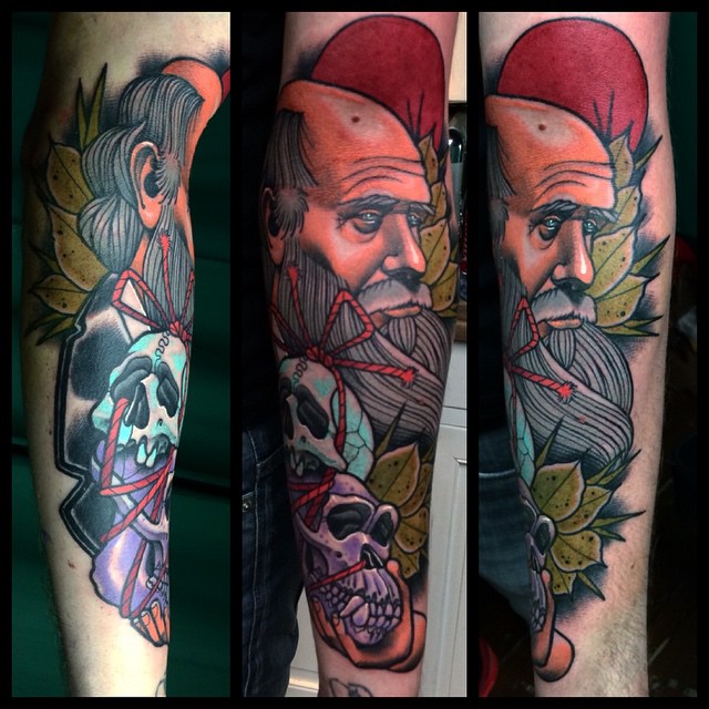 Darwin with Skulls Arm tattoo