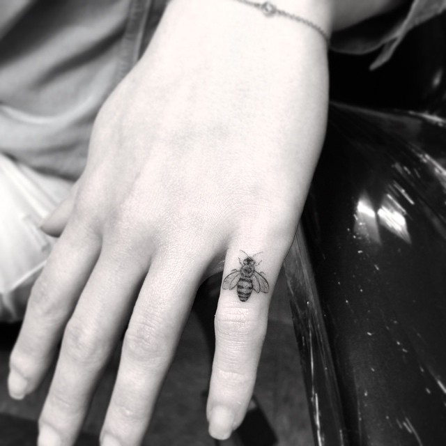 Tiny Bee Tattoo on Finger
