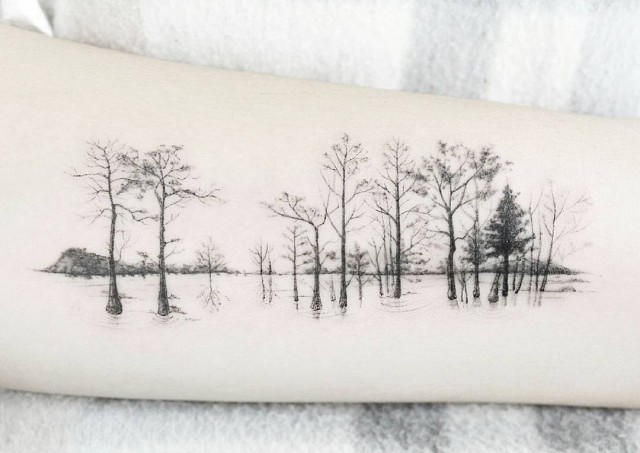 arm tattoo of trees with one color