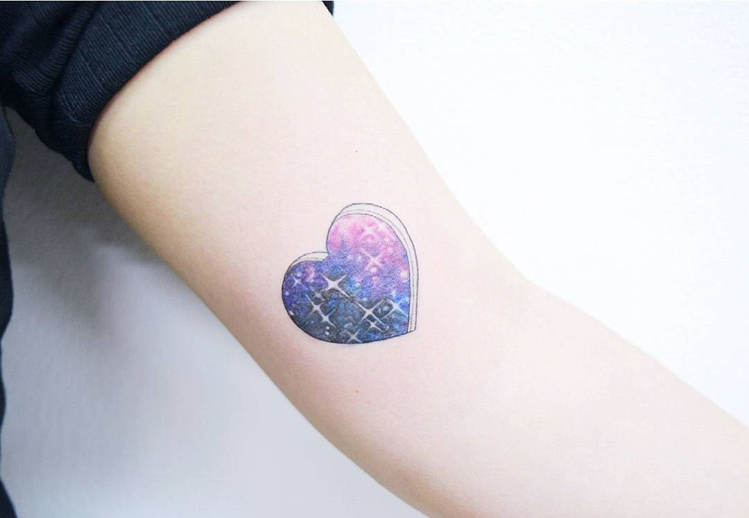 heart tattoo with a space pattern