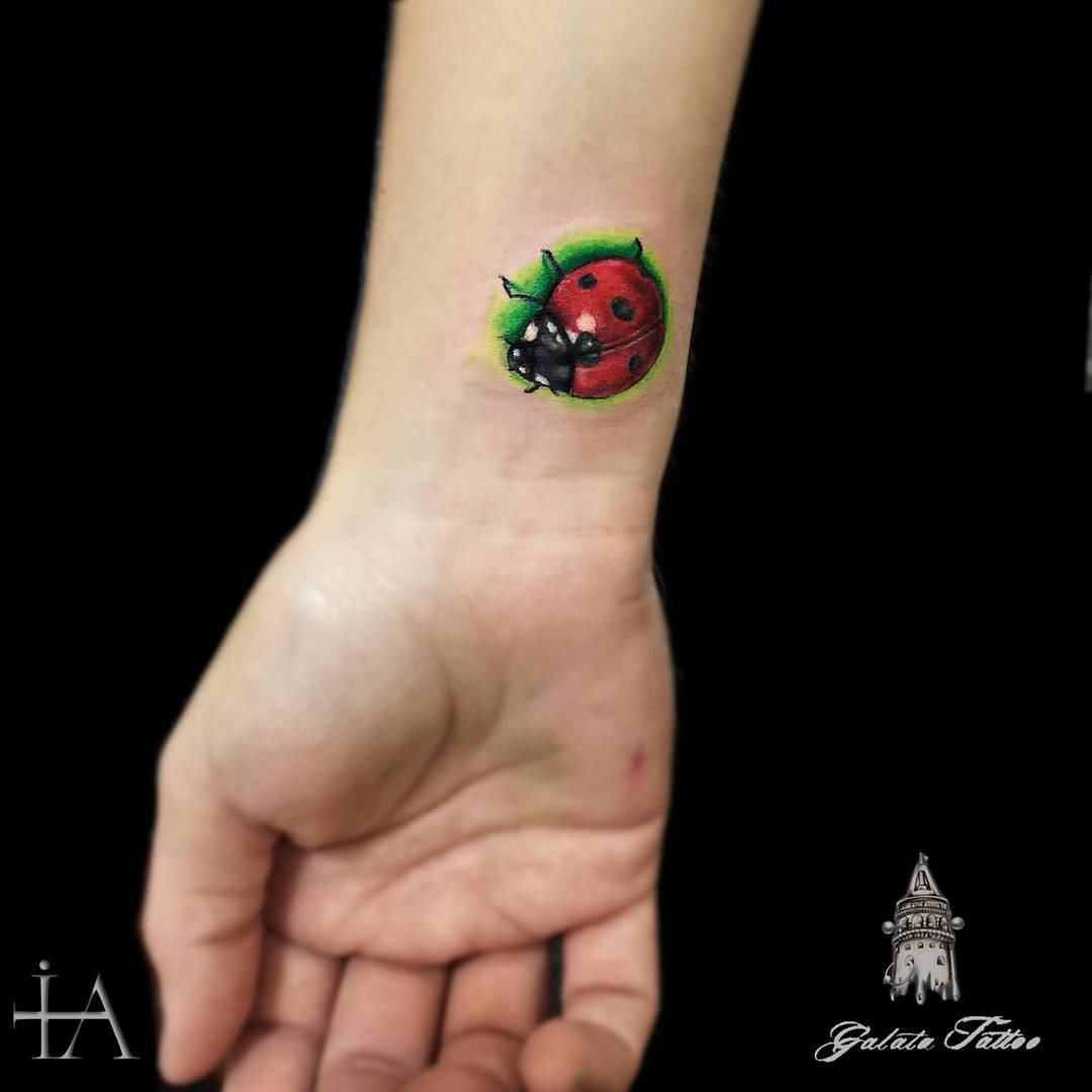 small ladybug tattoo on wrist
