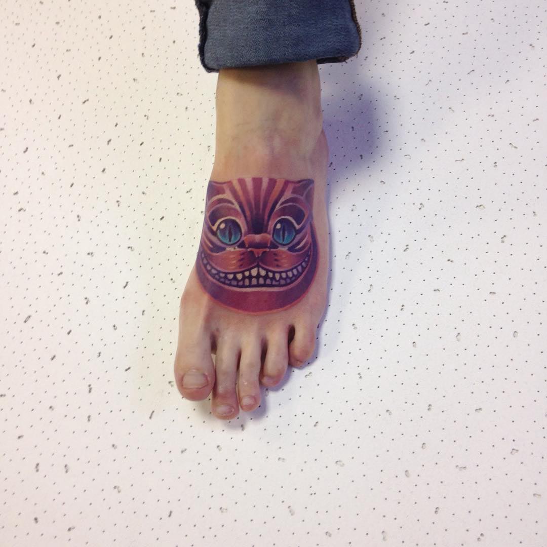 Cheshire cat tattoo on foot