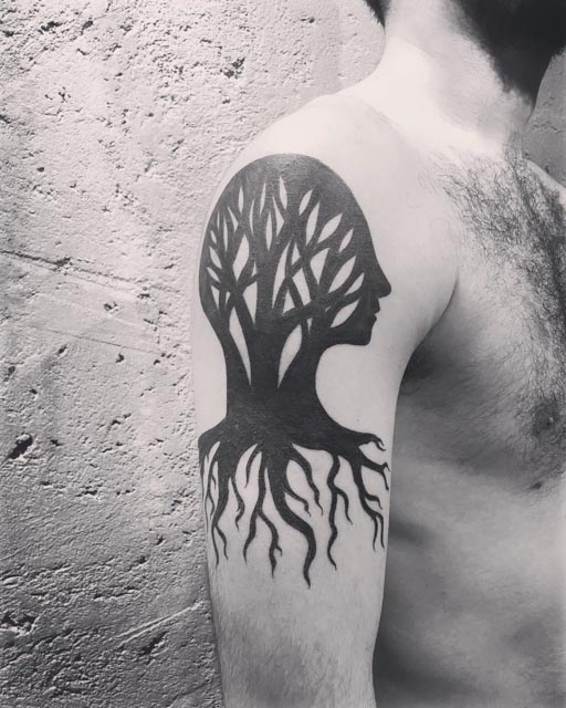 blackwork tree tattoo on shoulder