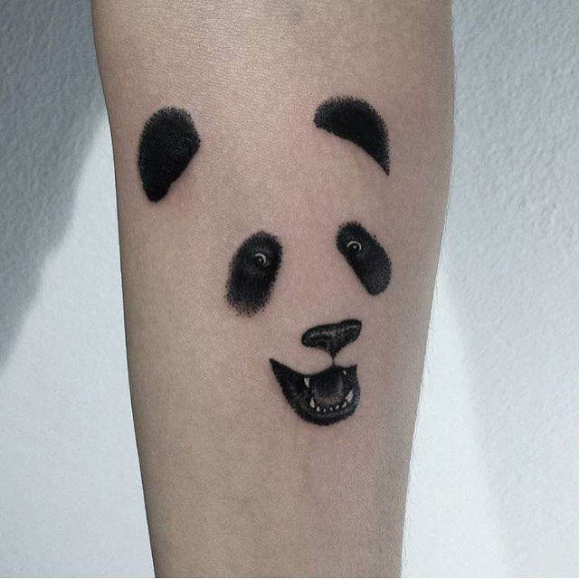 face of panda tattoo on arm