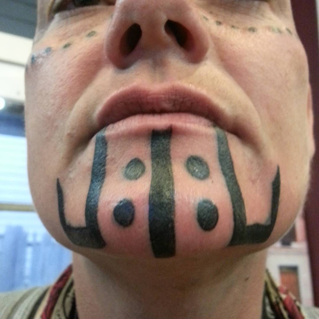 Black Tribal Chin Tattoo by brandontearztattoo