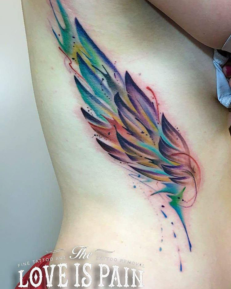 watercolor wing tattoo on ribs