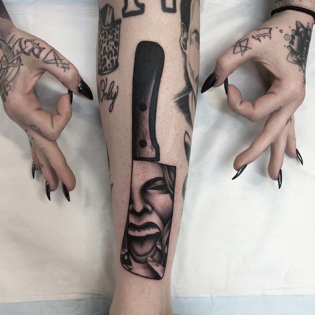 Knife tattoo with screaming girl