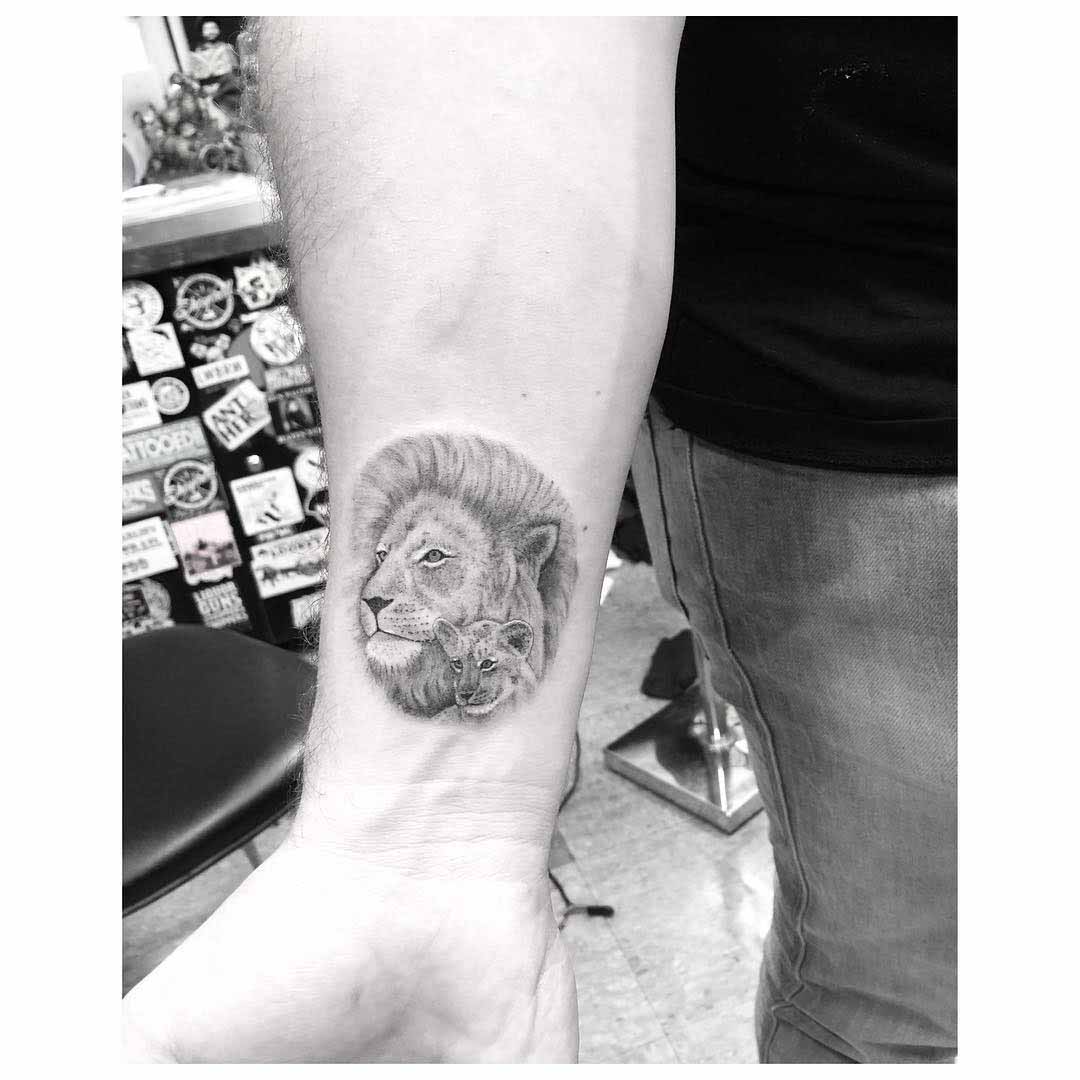 wrist tattoo lion and cub dotwork style