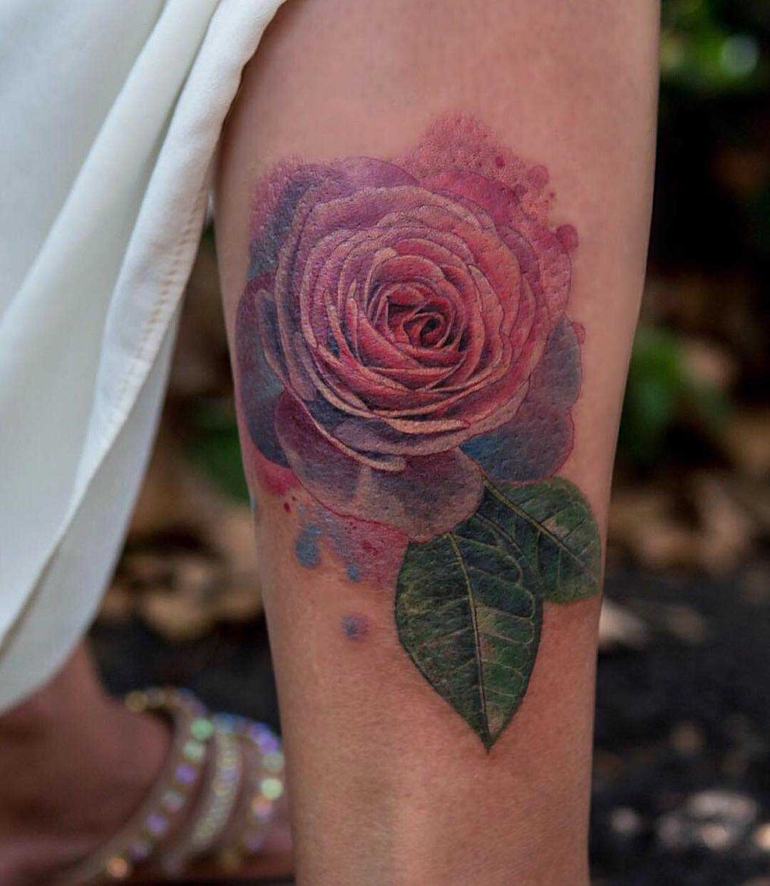 pink rose tattoo on forearm