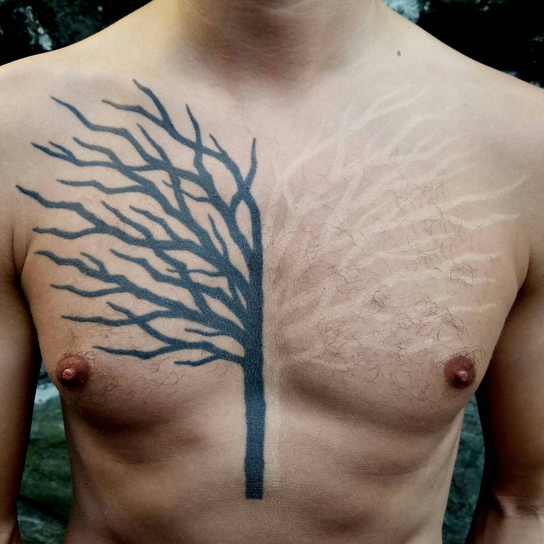 black and white tree tattoo on chest