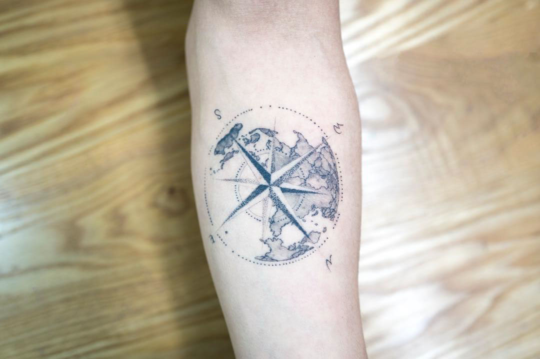 world map and compass tattoo