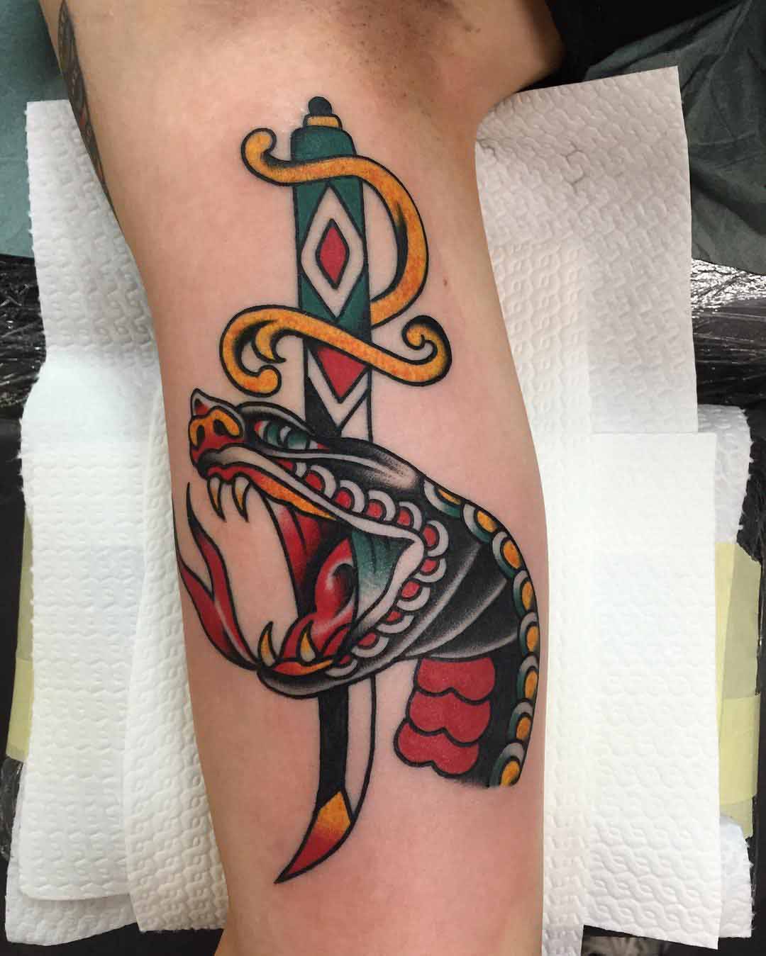 bicep tattoo dagger snake old school style