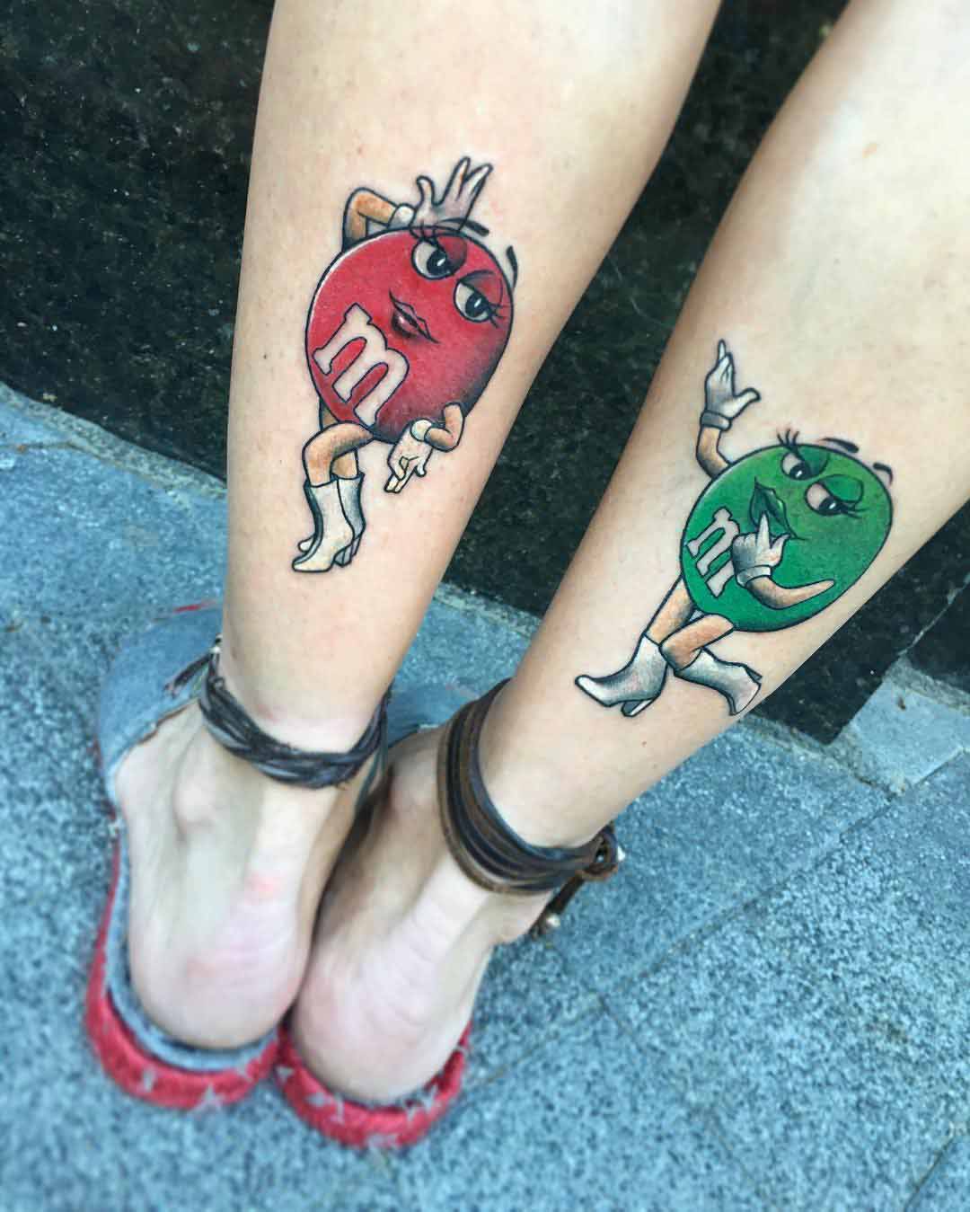 M&M tattoos on calves for sisters