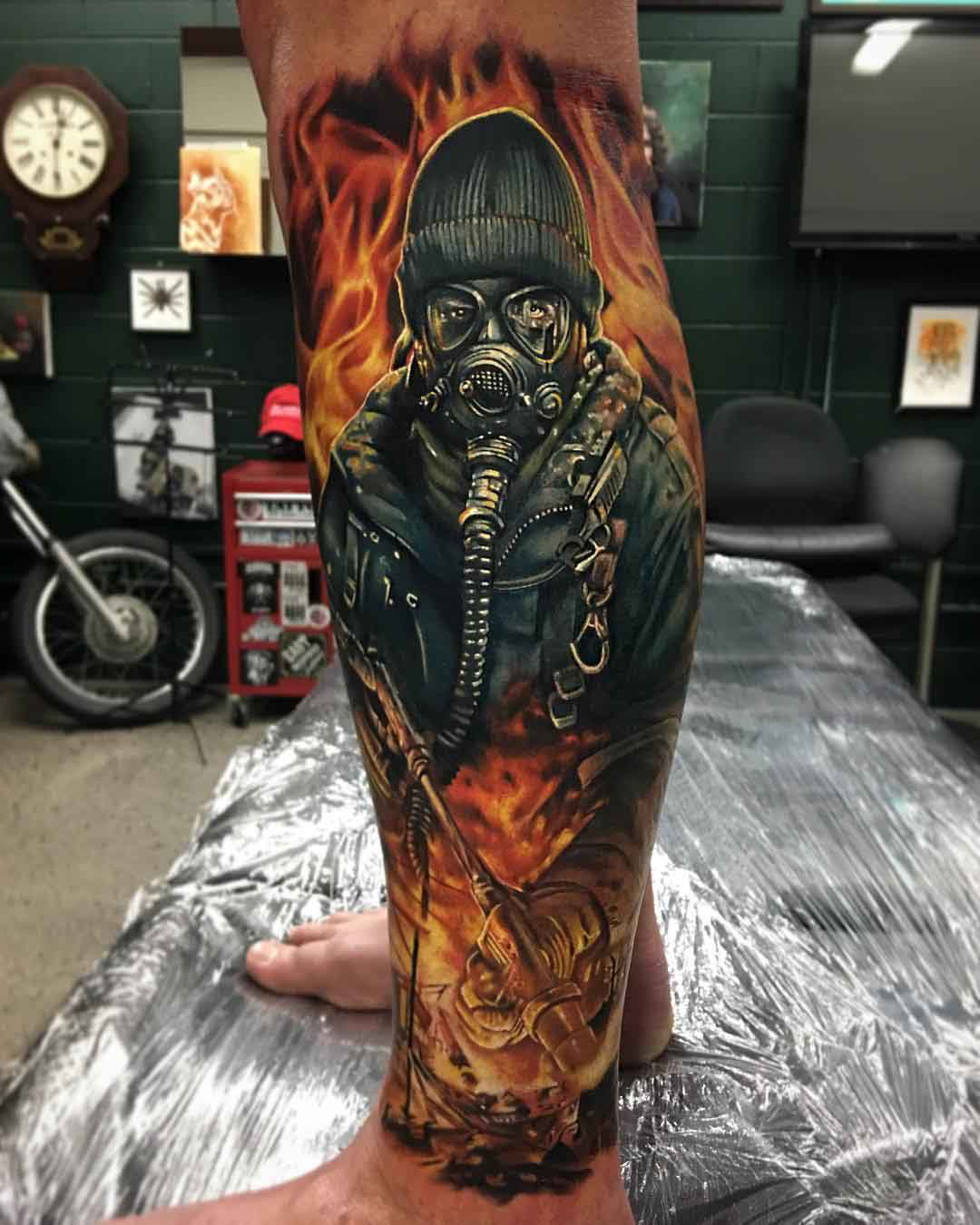 leg tattoo flaming man in gas mask