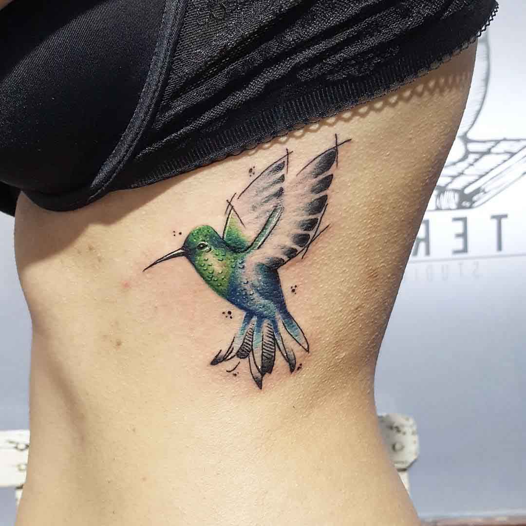 flying hummingbird tattoo on ribs