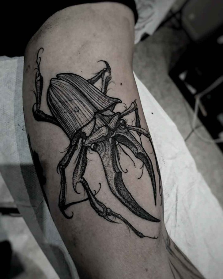 bicep tattoo stag beetle.