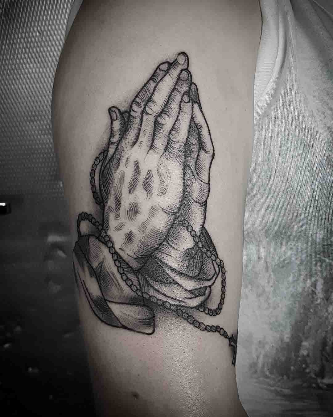 parying hands tattoo
