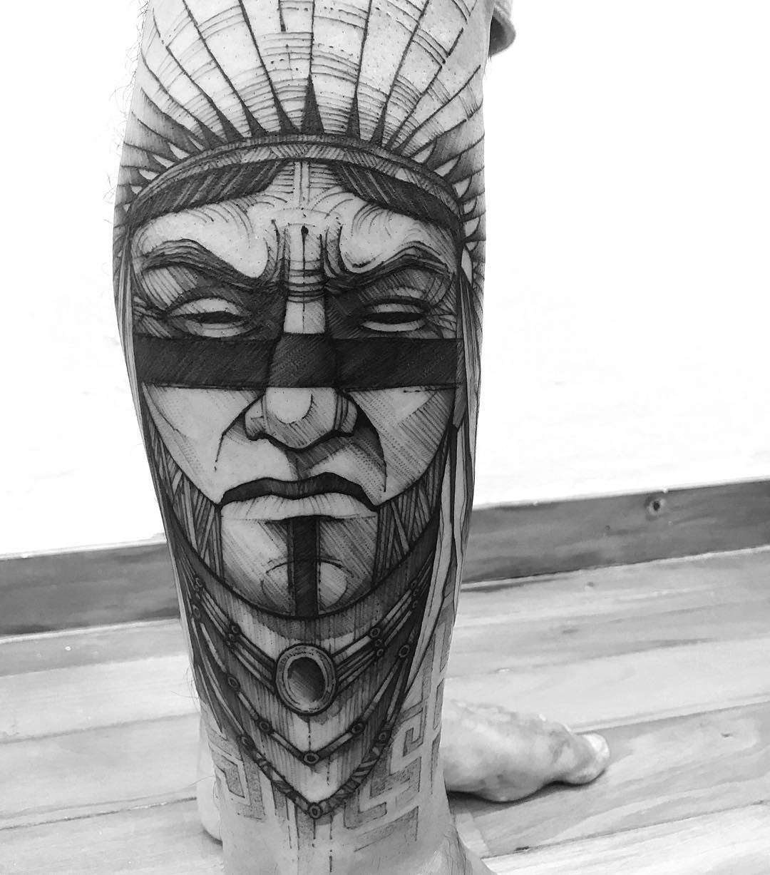 angry indian tattoo on leg