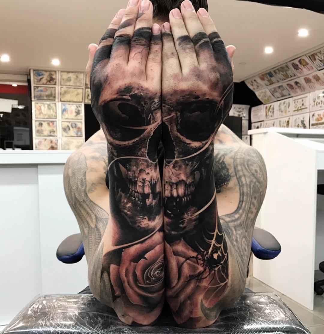 matching skull tattoo on forearms