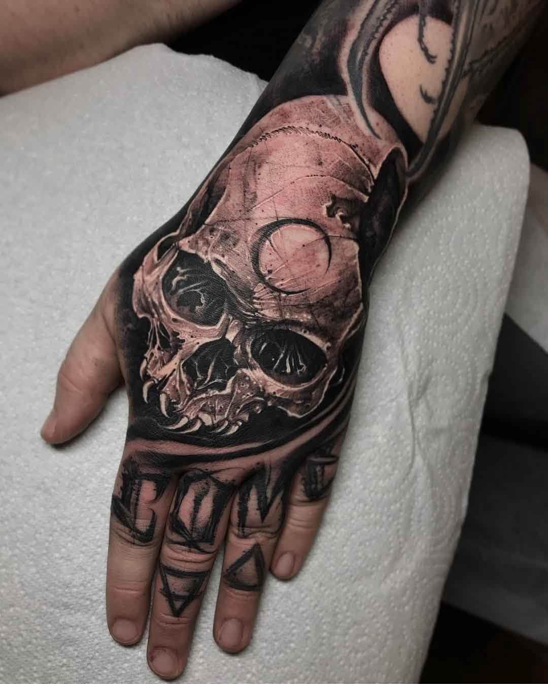 moon skull tattoo on hand