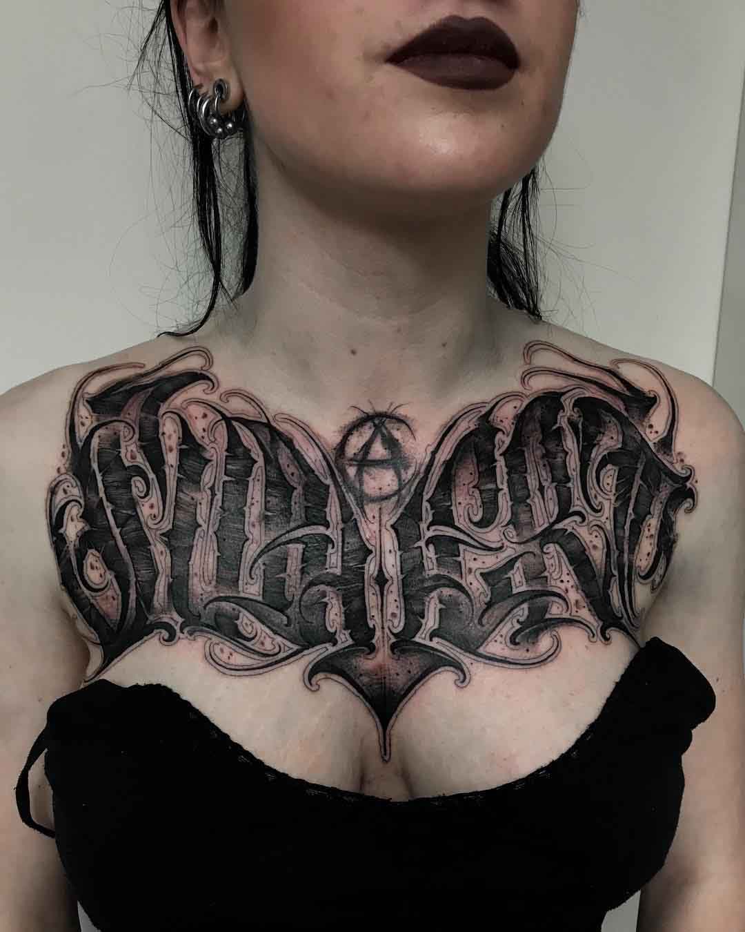 gothic lettering tattoo on chest
