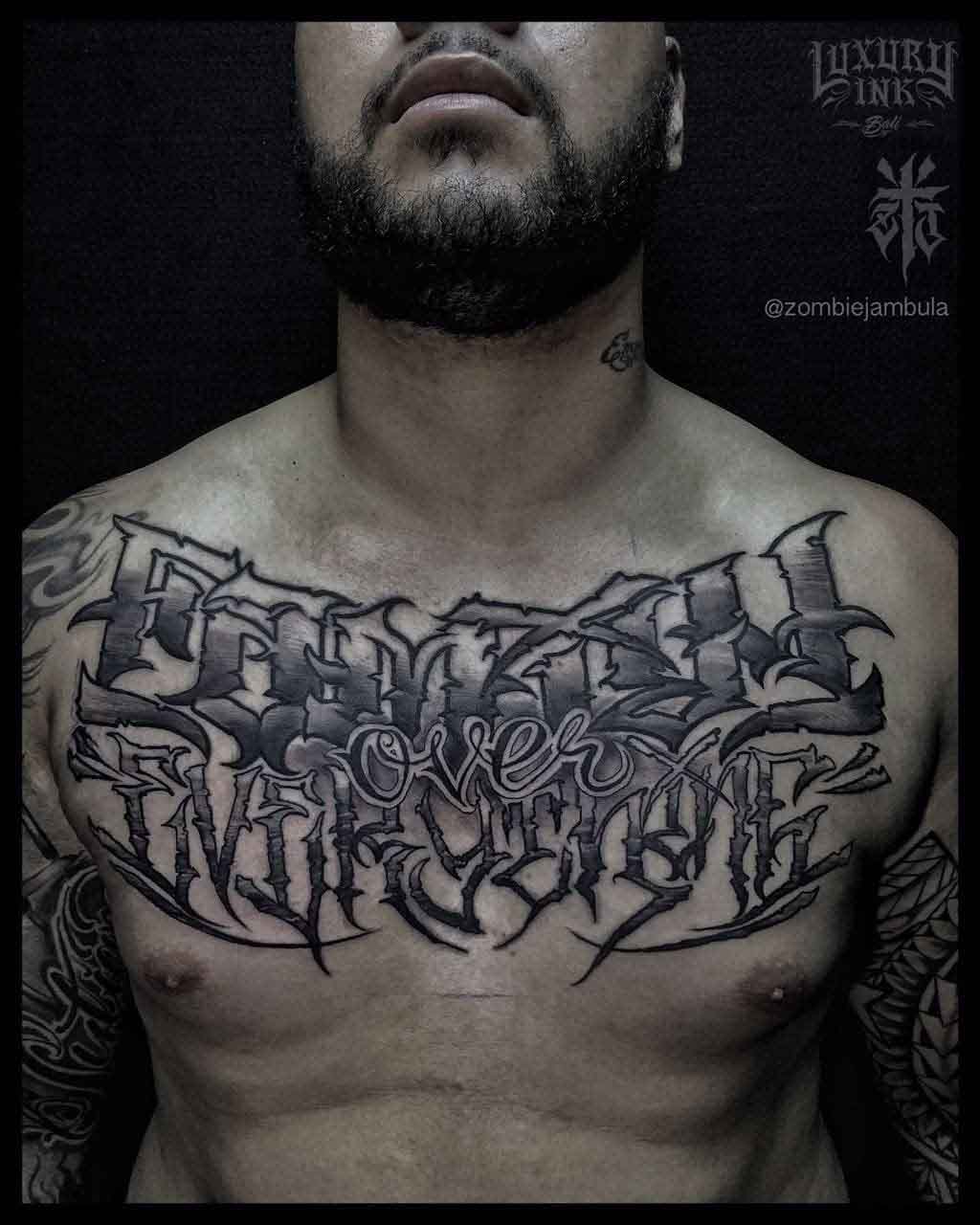 chest tattoo lettering "family ofver everything"