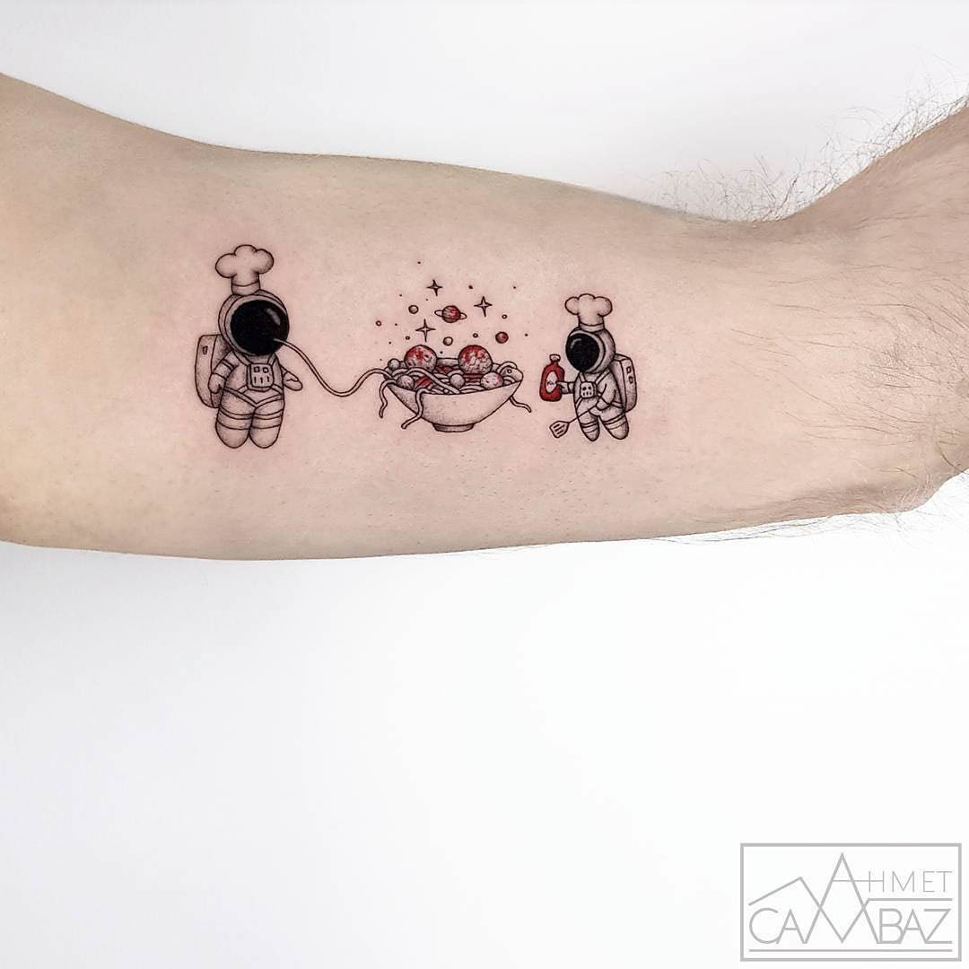 bicep tattoo spaghetti astronauts