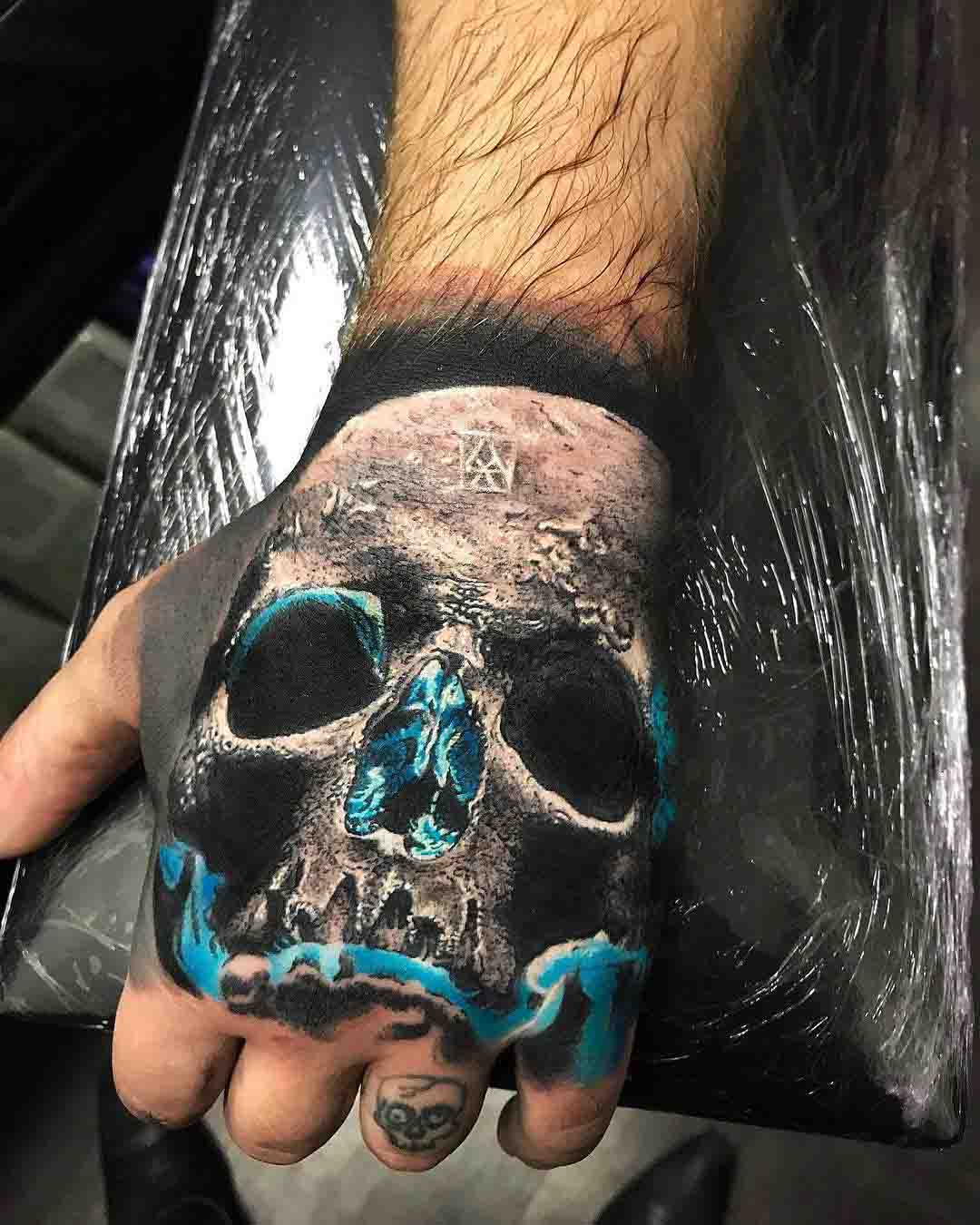 hand tattoo skull