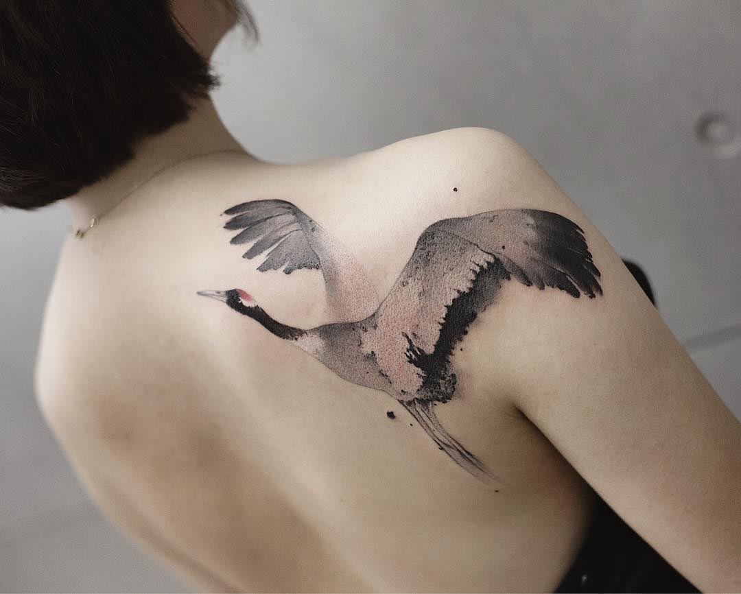 crane tattoo on shoulder blade