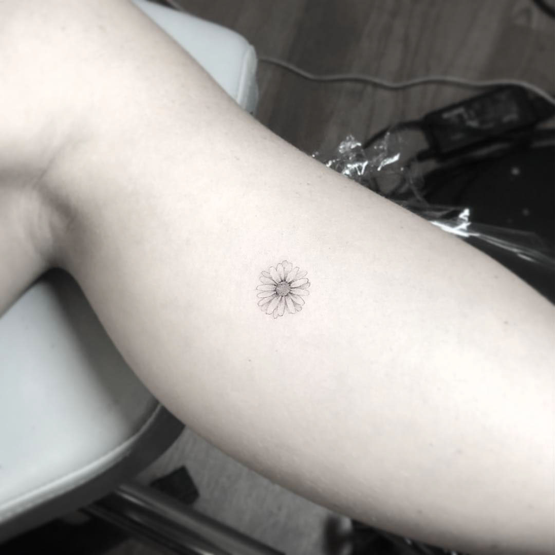 very small daisy tattoo
