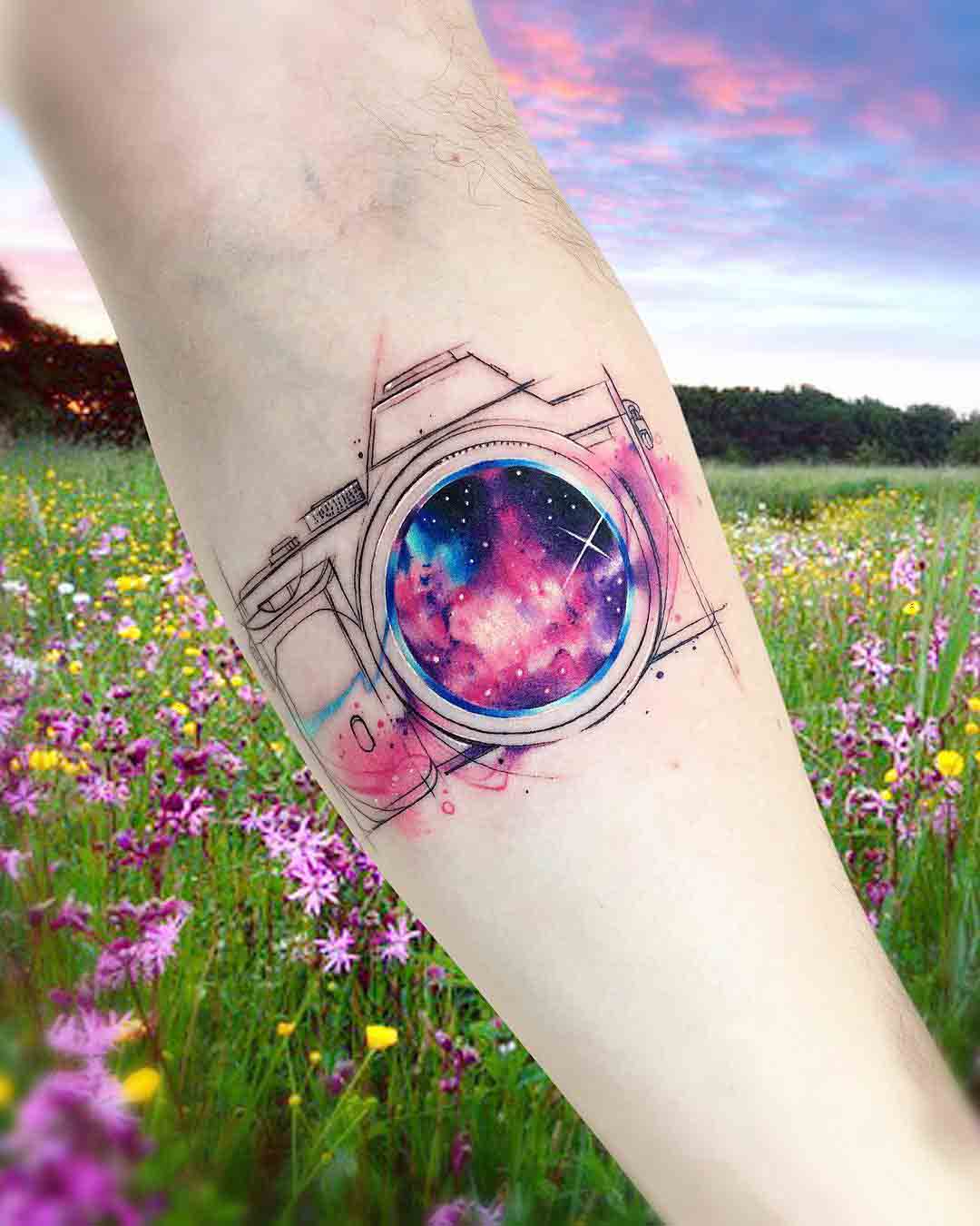arm tattoo camera universe lens